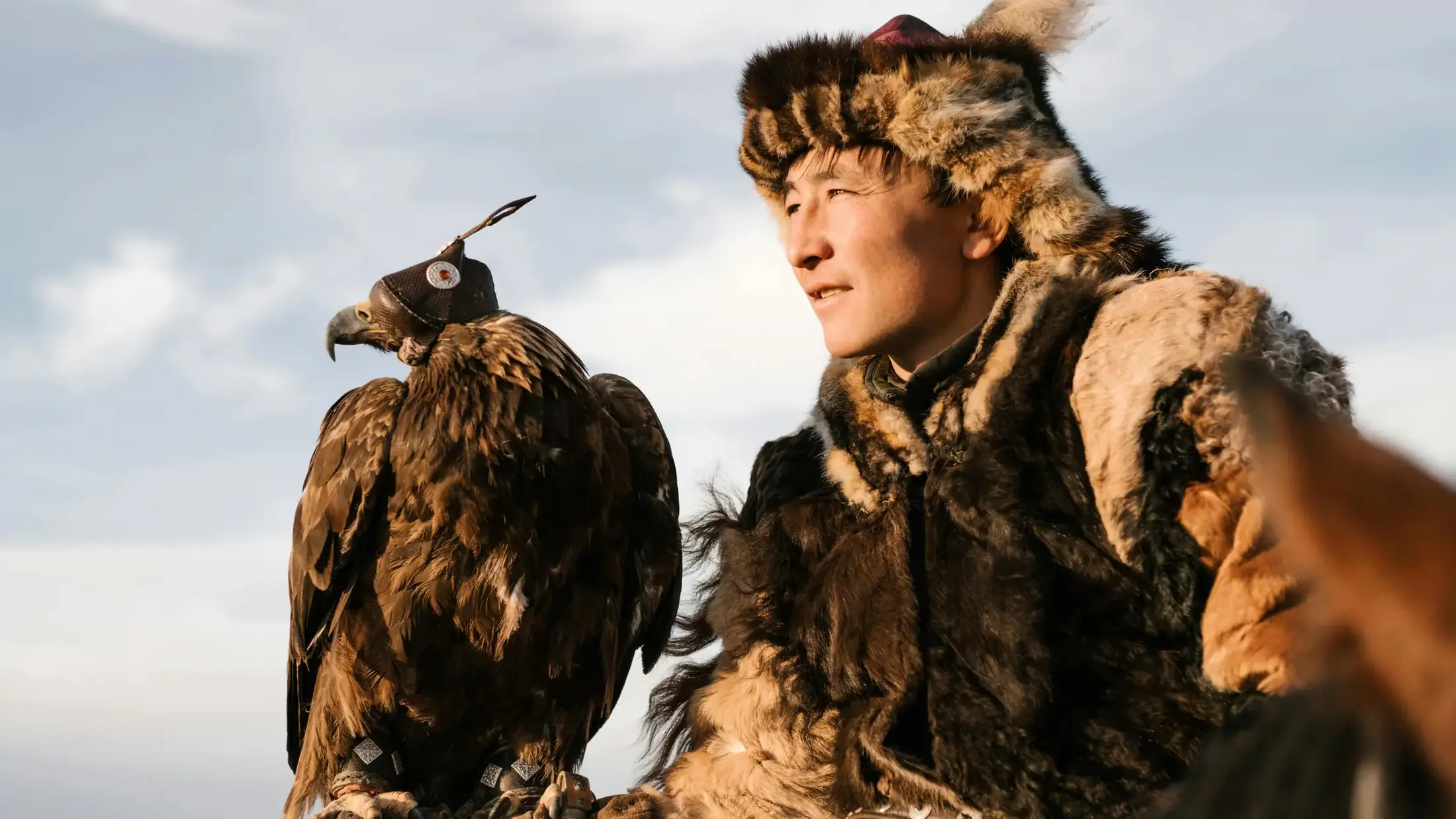 Kazakh eagle hunter with his golden eagle