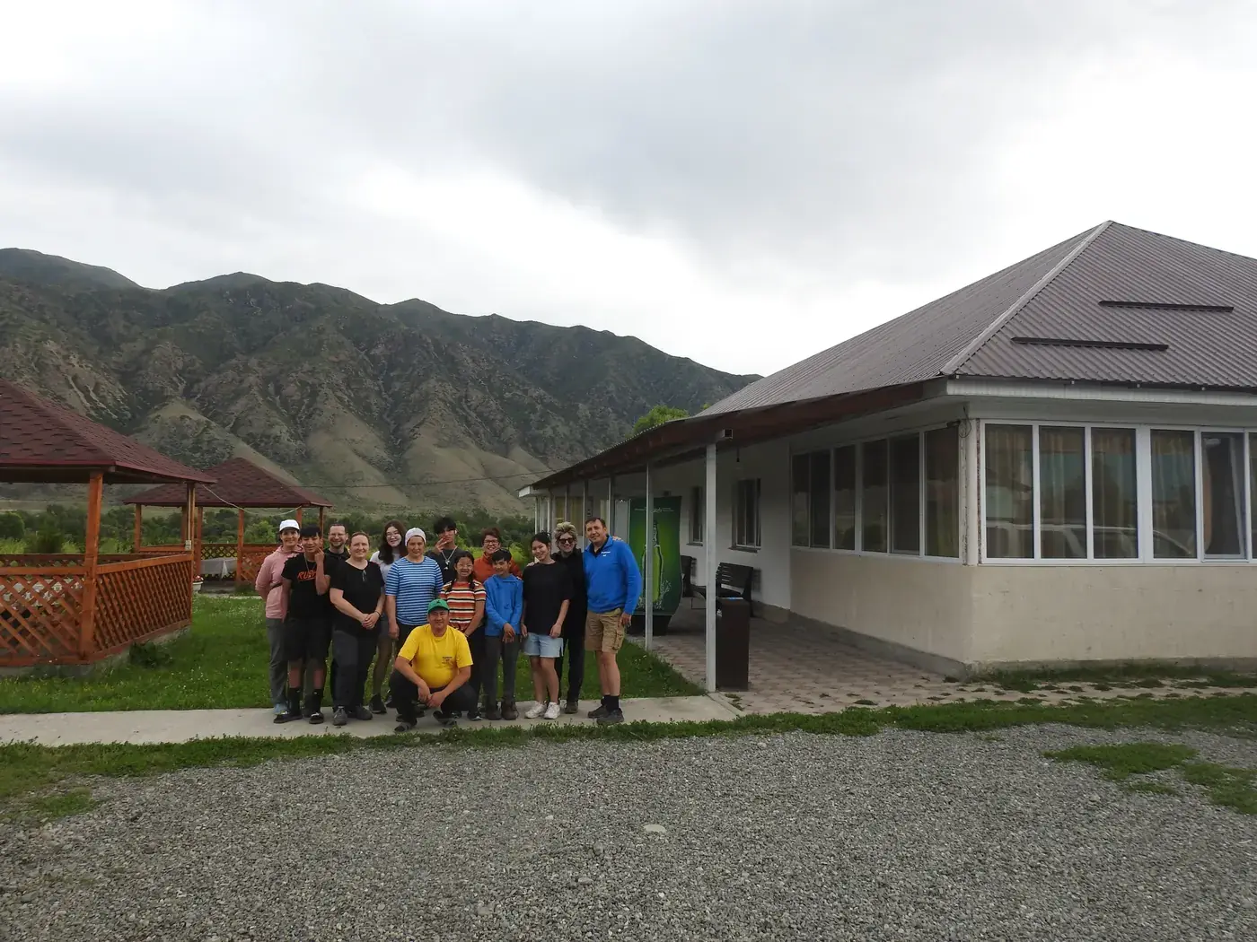 A group in front of a guesthouse in the mountains