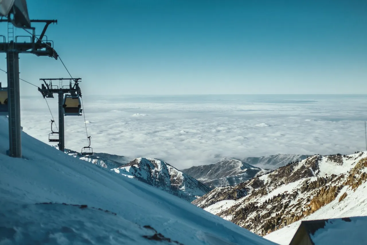 A chairlift above a sea of clouds in the mountains